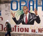 Fotografía de archivo de un hombre camina junto a un mural en homenaje al asesinado expresidente Jovenel Moise, en Puerto Príncipe (Haití). EFE
