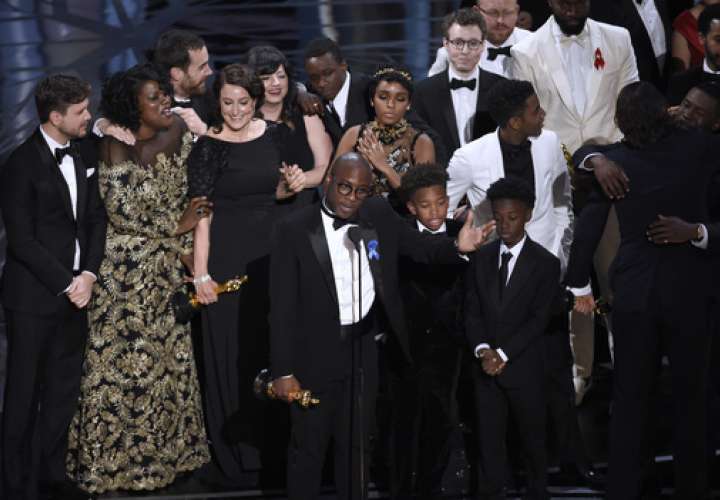 Barry Jenkins, foreground center, and the cast accept the award for best picture for 