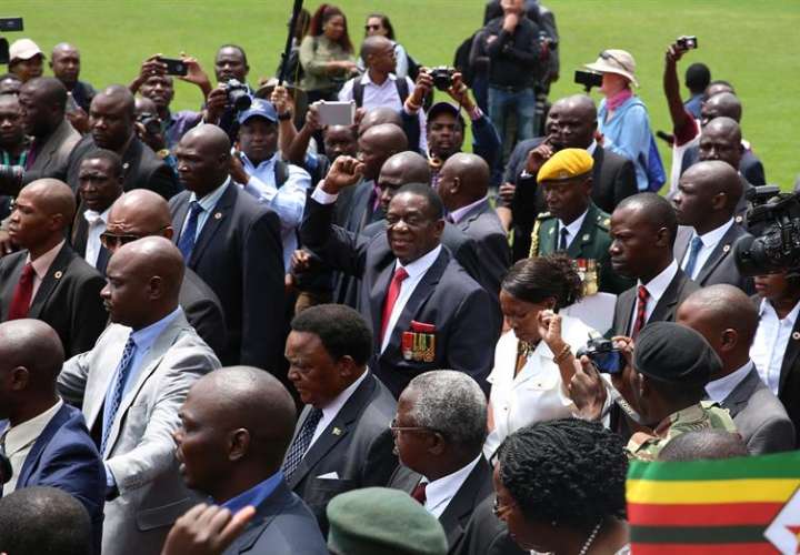  El presidente provisional de Zimbabue, Emmerson Mnangagwa (C), saluda a su llegada a la ceremonia de juramento oficial en el estadio nacional de deportes en Harare (Zimbabue). /  EFE