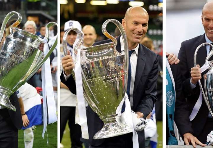 Zinedine Zidane, con los tres trofeos de Liga de campeones conseguidos de forma consecutiva; Milán (2016), Cardiff (2017) y Kiev (2018)./EFE