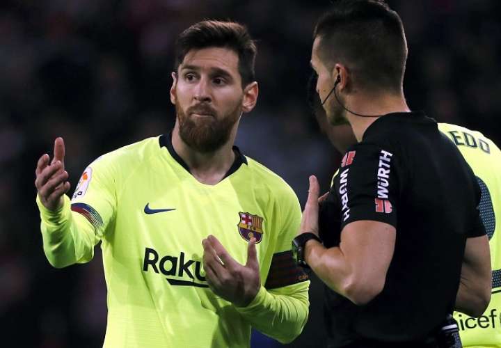 El delantero argentino del F.C Barcelona Leo Messi (i) ante el árbitro Del Cerro Grande./ EFE