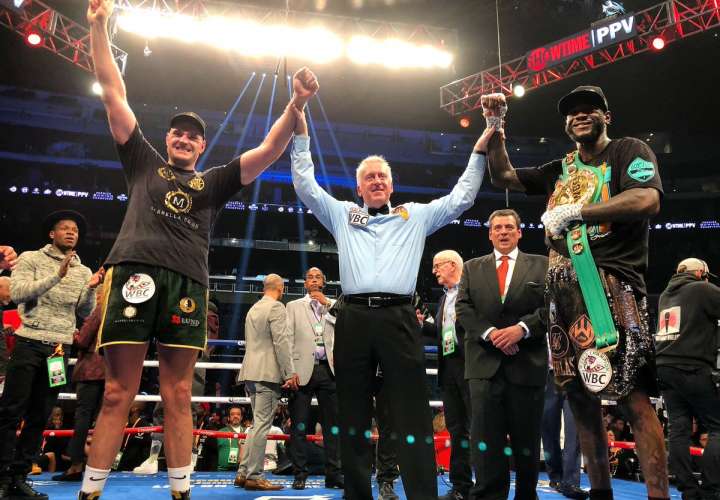 Tyson Fury (izq.) y Deontay Wilder luego de que se decretó el empate en la pelea.