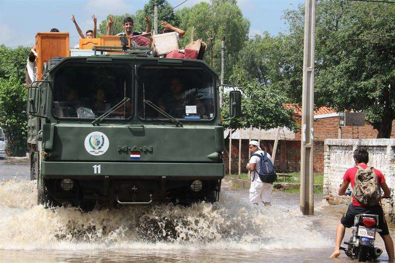 Un vehículo militar transporta familias hoy, martes 30 de enero de 2018, en un barrio de Asunción (Paraguay). EFE