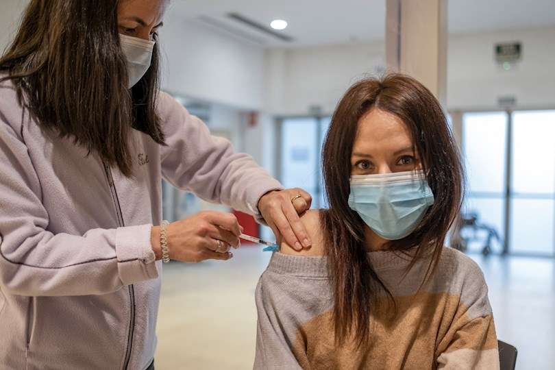Una mujer recibe la vacuna contra el coronavirus en el recinto ferial de Expourense en Ourense durante la campaña de vacunación de la tercera dosis en Galicia al grupo de edad de entre 30 y 39 años.Archivo. EFE