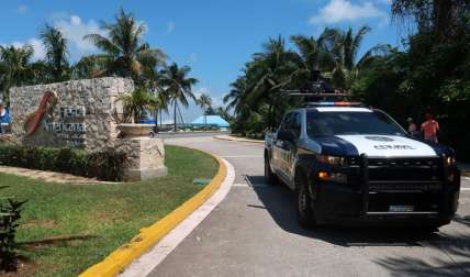 Agentes forenses se presentan en el lugar donde un tiroteo que dejó tres personas muertas, hoy, en la playa de un hotel del balneario de Cancún, Quintana Roo (México).  EFE